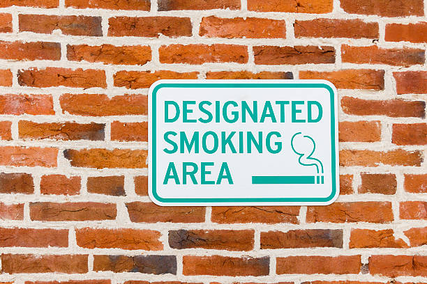 Designated Smoking Area Sign On a Red Brick Wall