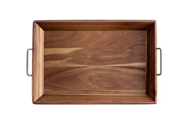 Decorative rectangular olive wood tray showing the light and dark pattern of the grain with brass handles, overhead view isolated on white