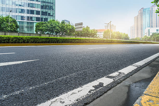 istock clean asphalt road with city skyline background 598953668