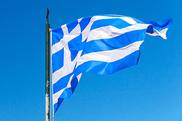 istock Flag of Greece waving over clear blue sky 598956948