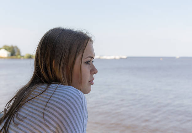 istock thoughtful girl at the sea 598957476