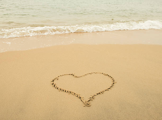 istock heart in sand on a beautiful beach 598958986