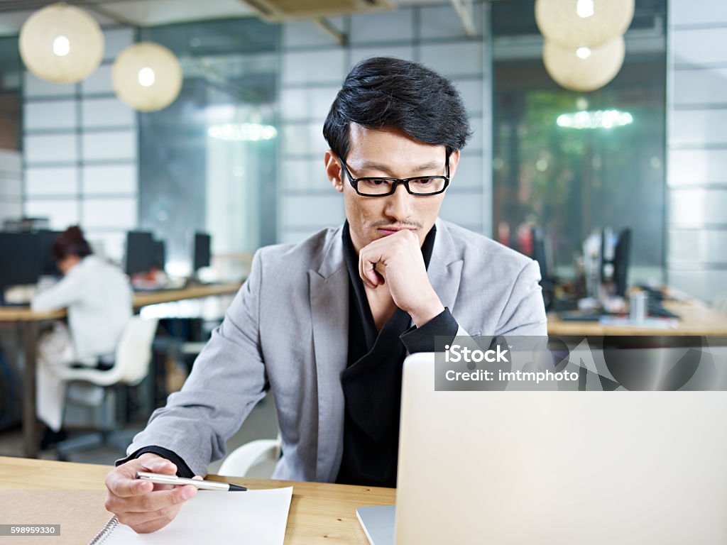 young asian businessman working in office young asian business man working in office using laptop computer. Asia Stock Photo