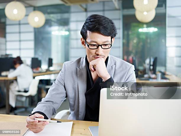 Young Asian Businessman Working In Office Stock Photo - Download Image Now - Asia, Men, Asian and Indian Ethnicities