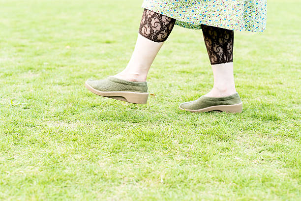 istock Walking woman on the green field 598961436