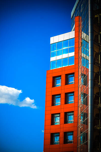 istock modern building on a background of blue sky with clouds 598961540