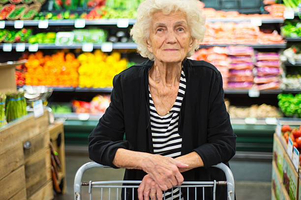 senior woman shopping nel negozio di alimentari - senior adult aging process supermarket shopping foto e immagini stock