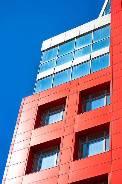 istock modern building on a background of blue sky with clouds 598962038