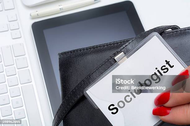 Woman Showing Her Occupation On A Name Tag Stock Photo - Download Image Now - Adult, Bag, Computer Keyboard