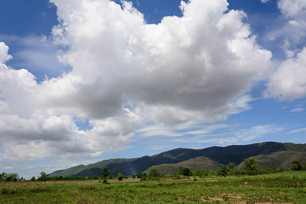 istock farm with mountain against cloudy sky background 598963802