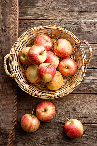 istock fresh apples in wicker basket on wooden table 598963864