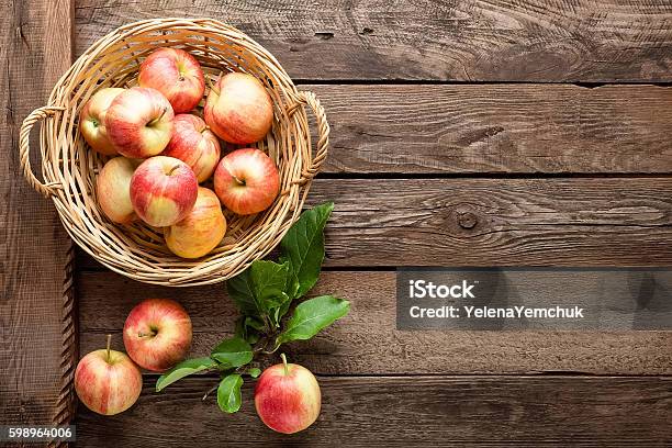 Fresh Apples In Wicker Basket On Wooden Table Stock Photo - Download Image Now - Apple - Fruit, Basket, Table