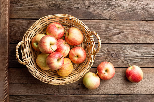 istock fresh apples in wicker basket on wooden table 599099442
