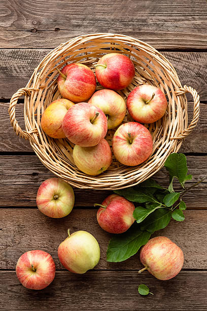 istock fresh apples in wicker basket on wooden table 599099590