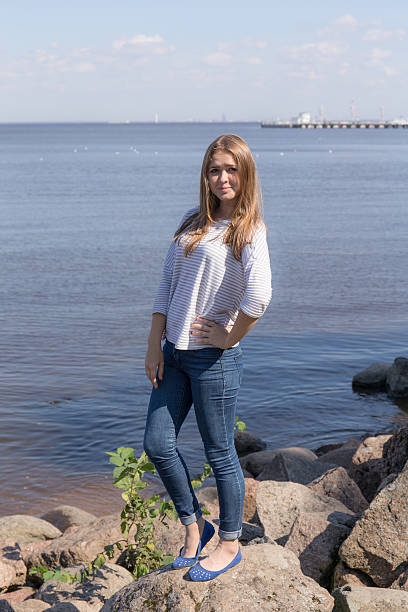 istock girl standing on rocks 599100276