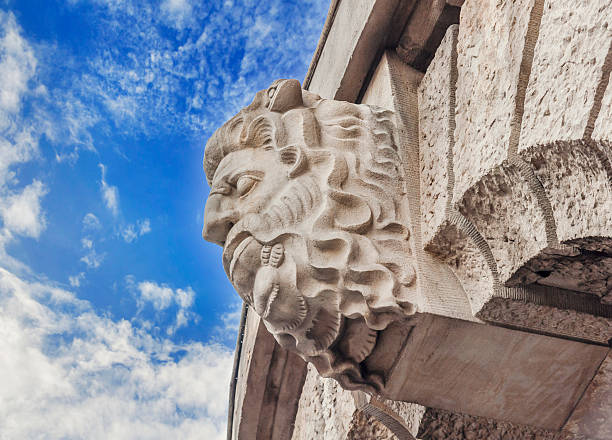 istock Historic building detail man head with blue cloudy sky 599100438