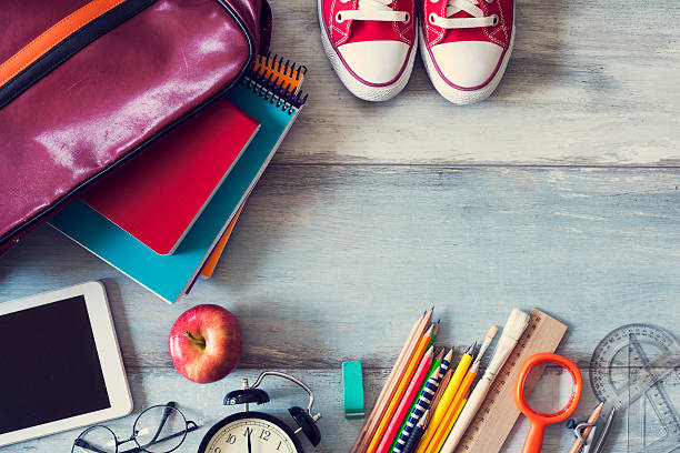 istock School supplies on wooden background 599100642