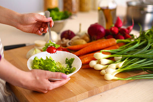 istock Cook's hands preparing vegetable salad - closeup shot 599101500
