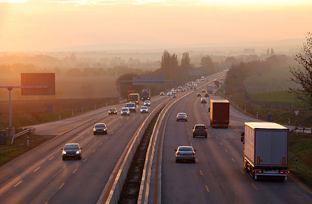 istock Cars on highway road at sunset 599102584