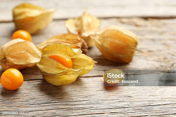 Ripe Physalis On A Grey Wooden Table Stock Photo - Download Image Now - Berry Fruit, Colors, Dessert - Sweet Food