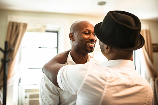 istock Gay couple dancing together at home 599105662