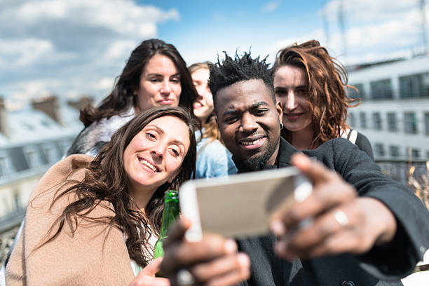 group of friends take a selfie on the rooftop in paris