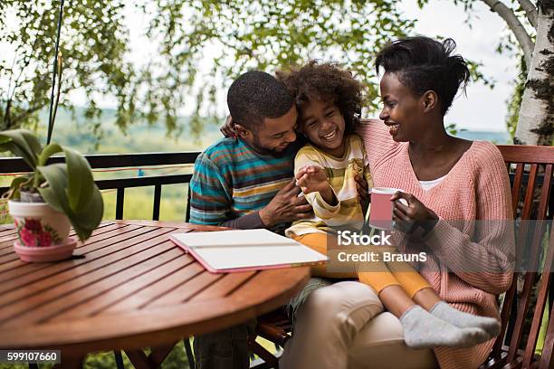 Playful African American Family Having Fun On A Terrace Stock Photo - Download Image Now