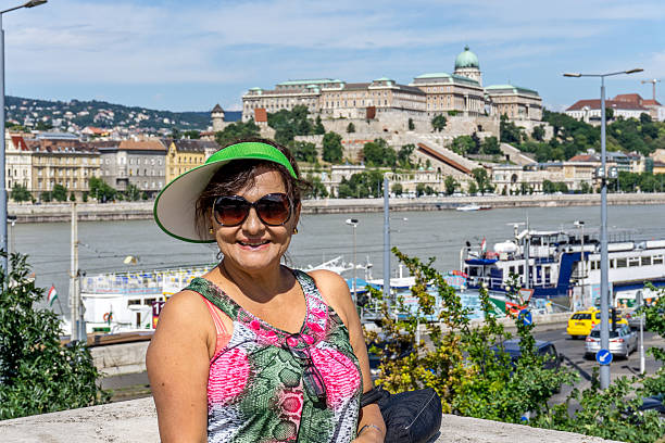 Mature hispanic woman smiling on balcony