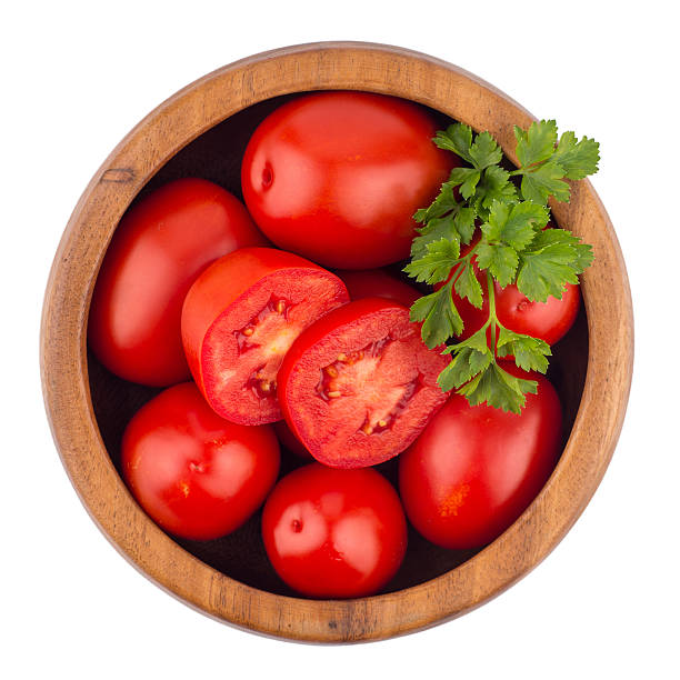 istock fresh tomatoes in wood bowl on white background. 599108868
