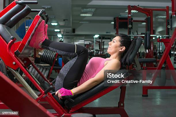 Girl Doing The Leg Press Stock Photo - Download Image Now - Leg Press, Women, Activity