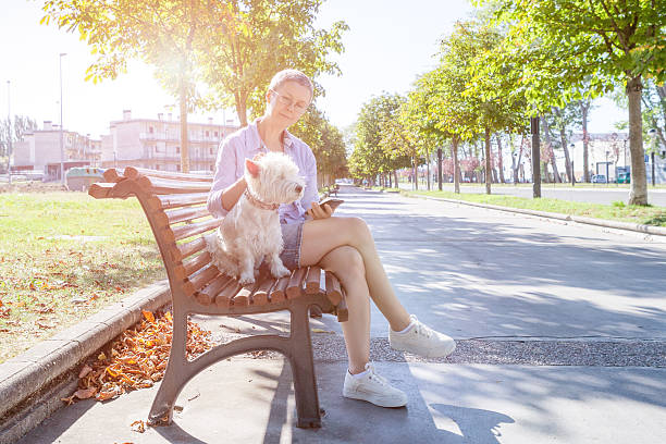 istock Woman with the dog on the bench 599111006