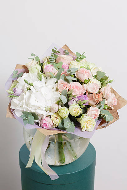 istock White background, glass vase with Mixed bouquet. beautiful flowers still 599111392