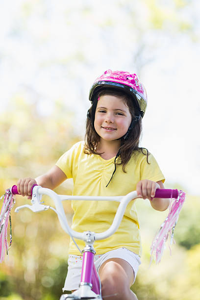 istock Smiling girl riding a bicycle 599112244