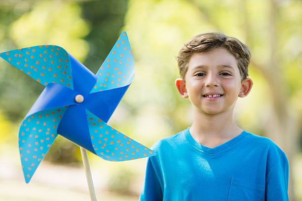 istock Boy holding a pinwheel in park 599112376