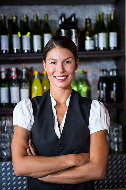istock Smiling waitress with arms crossed 599112572