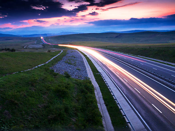 istock light trails on motorway highway at night, long exposure abstract 599113674