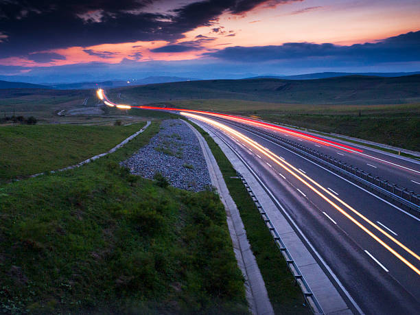 istock light trails on motorway highway at night, long exposure abstract 599113726