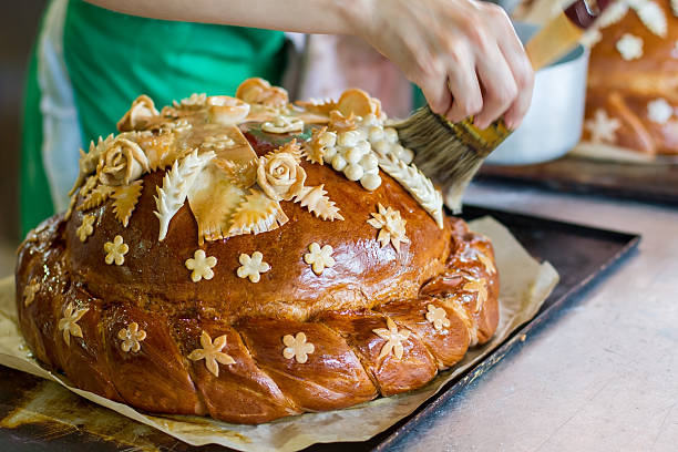 Hand with brush touches bread.