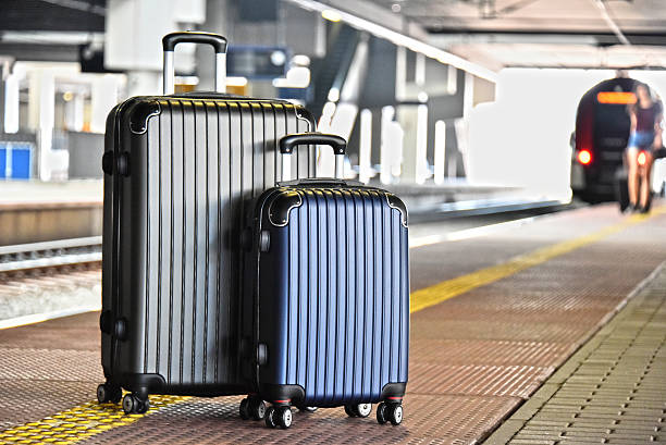 istock Two plastic travel suitcases on the railroad platform 599115652