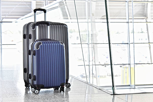 istock Two plastic travel suitcases in the airport hall 599116038