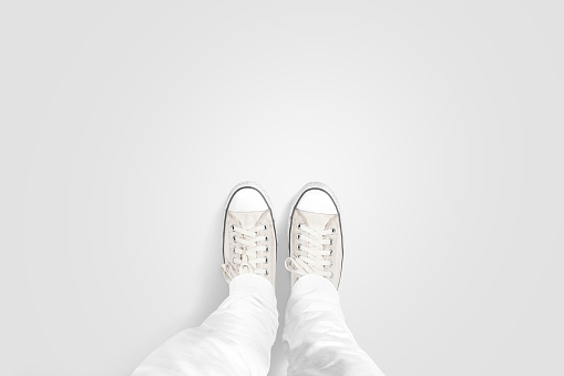 Person taking photo of his foots stand on blank floor, isolated, top view, clipping path. Ground design mock up. Man wear gumshoes and watching down. Deck flooring mockup template.