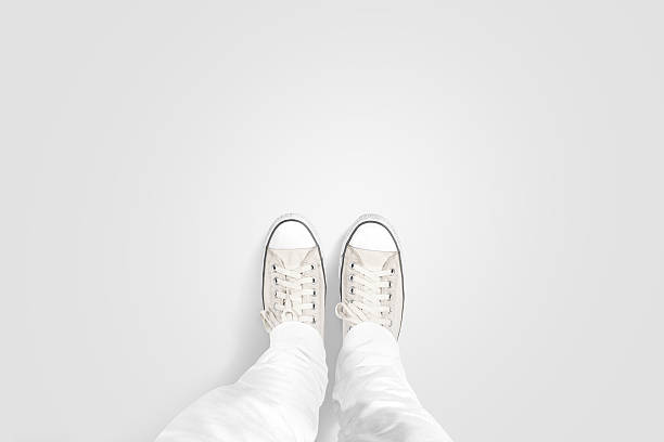 Person taking photo of his foots stand on blank floor Person taking photo of his foots stand on blank floor, isolated, top view, clipping path. Ground design mock up. Man wear gumshoes and watching down. Deck flooring mockup template. flat shoe photos stock pictures, royalty-free photos & images