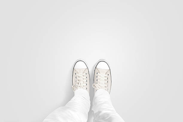 person taking photo of his foots stand on blank floor - down view imagens e fotografias de stock