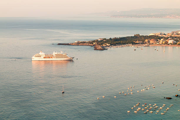 izmir, Turkey - March 26, 2020: Aerial view of a cruise ship leaving the aegean harbour of Çesme for mediterranean trip.