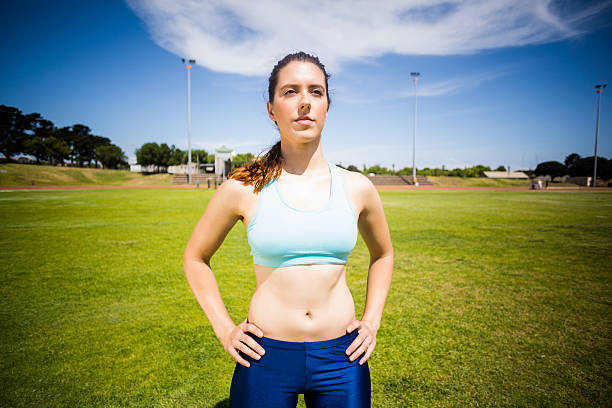 istock Confident female athlete standing with hand on hip 599119954