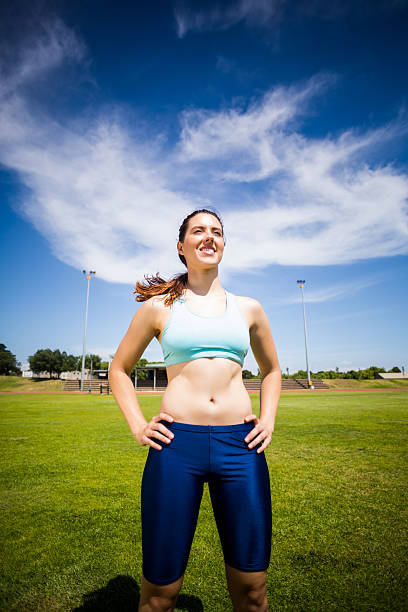 istock Confident female athlete standing with hand on hip 599120000
