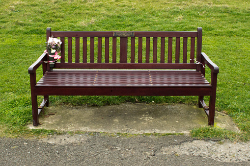 A newly placed wooden slated and metal frame public bench in Brighton during the 2020 pandemic.