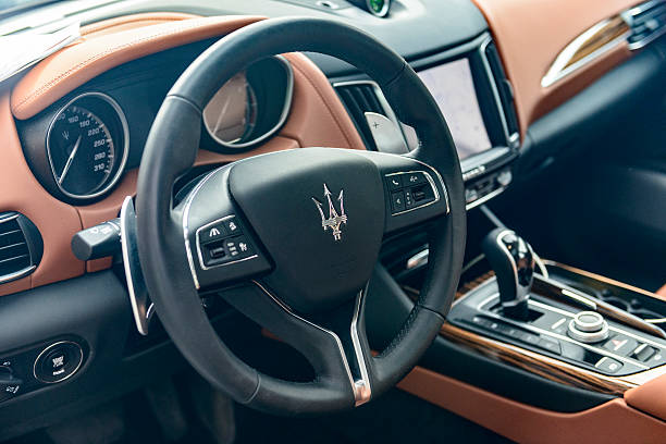 Zwolle, The Netherlands - September 3, 2016: Dashboard in a Maserati Levante Italian luxury SUV parked on the street in the city of Zwolle. The Levante is fitted with Maserati's 3.0L V6 engine and luxurious interior with leather seats, wood trim and large TFT information displays.