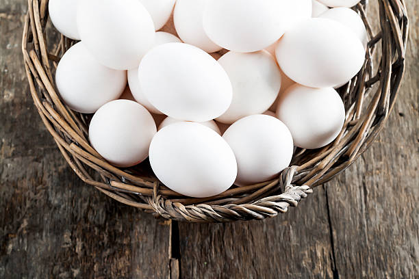 istock Chicken eggs in the basket on wooden background 599124056