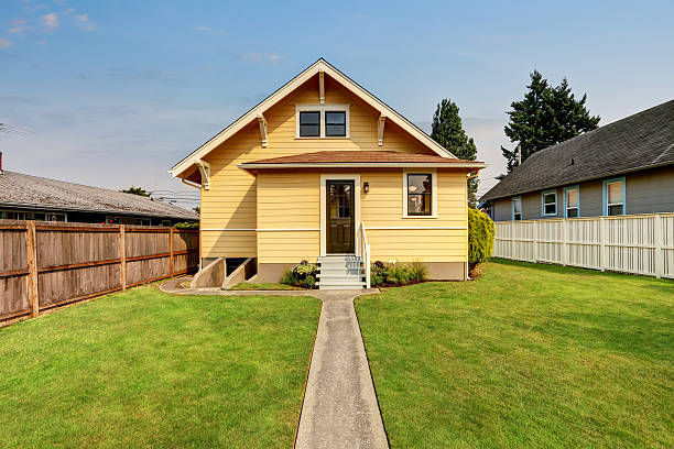 istock Backyard view of yellow siding craftsman house. 599124594